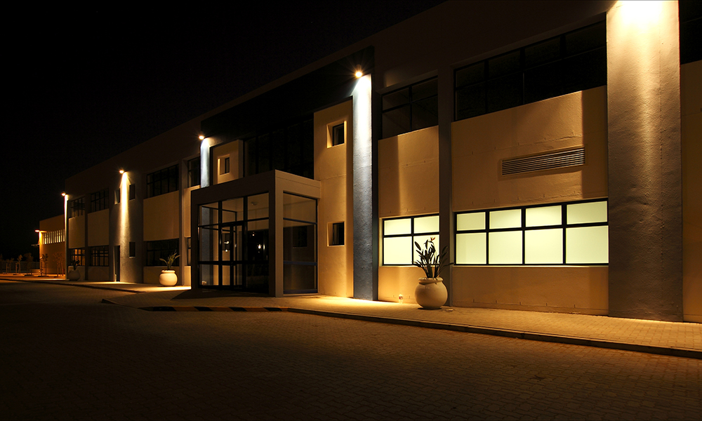 External,View,Of,A,Modern,Building,At,Night,With,Security